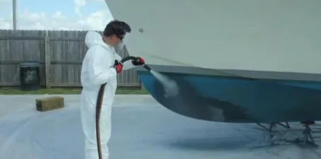 A boat hull being prepared with abrasive blasting